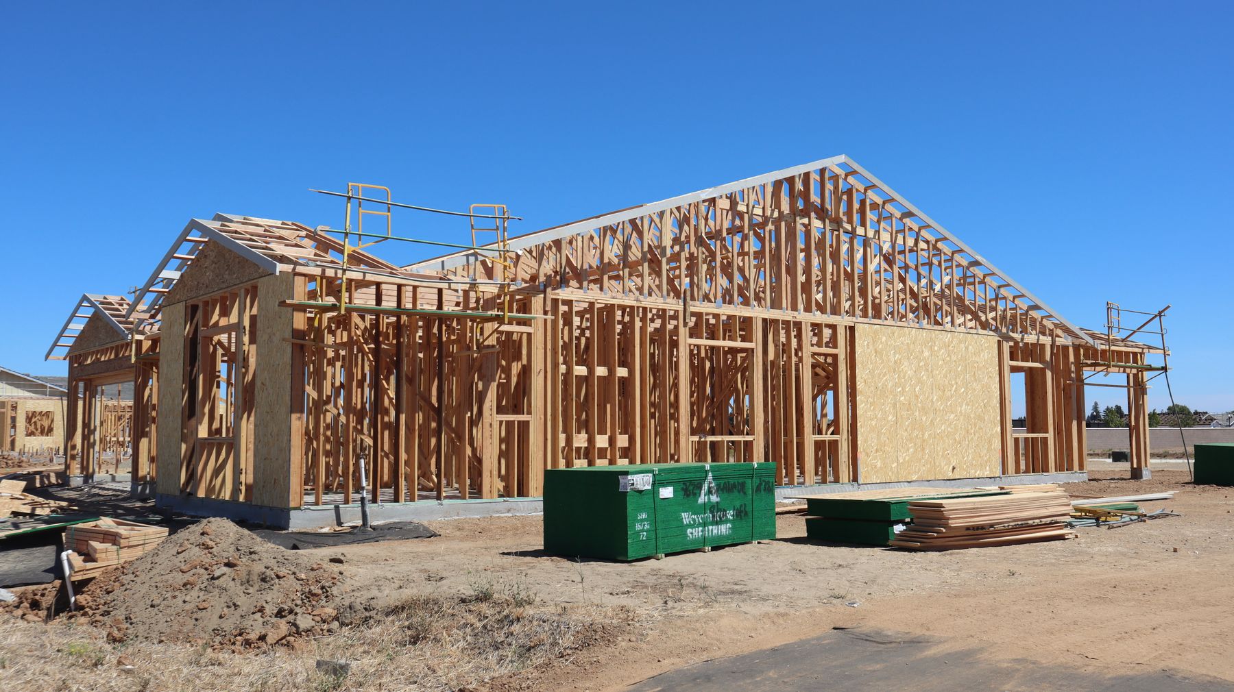 Wood-framed house under construction seen from the street