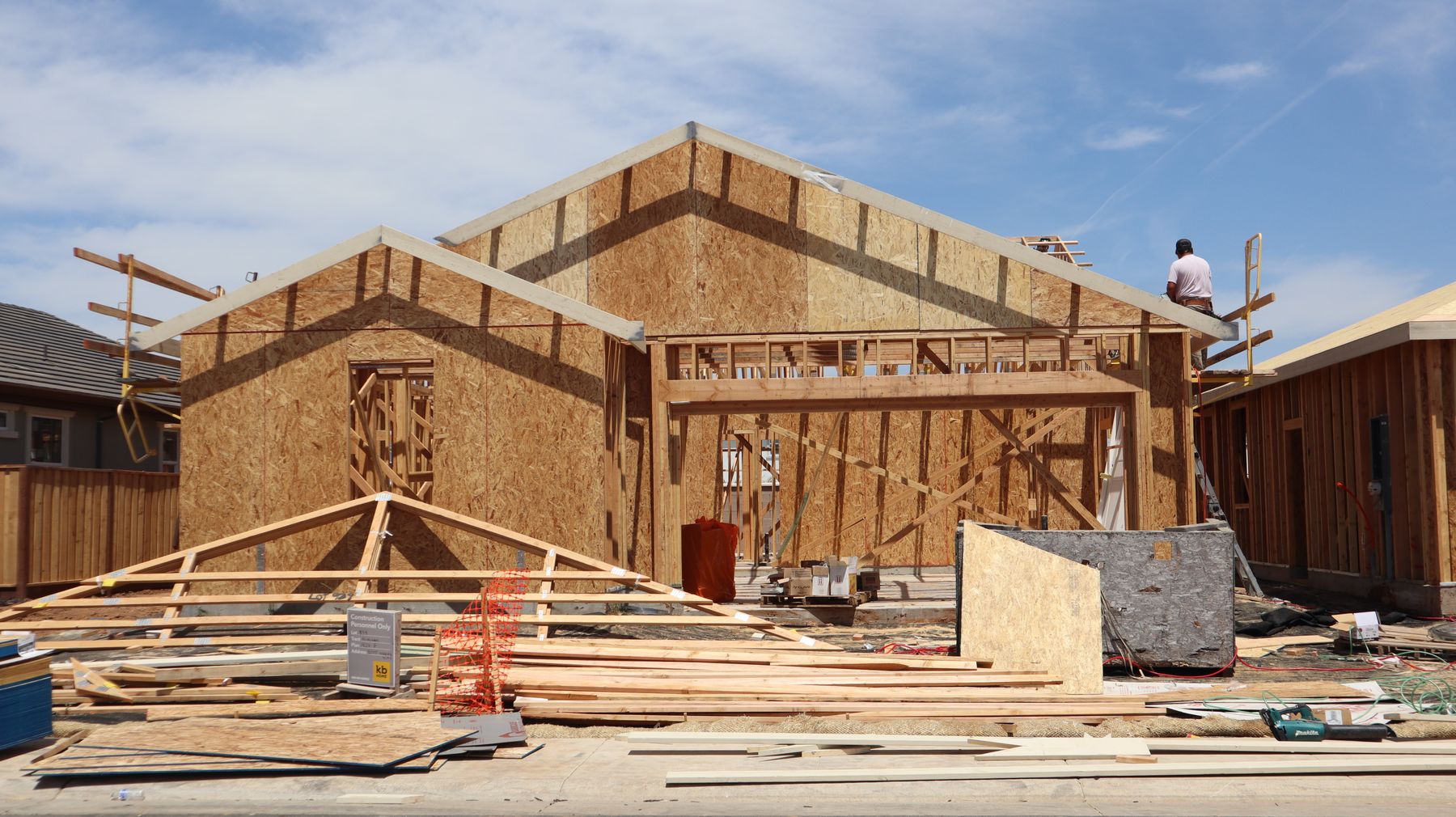 Roof trusses being framed against a blue sky