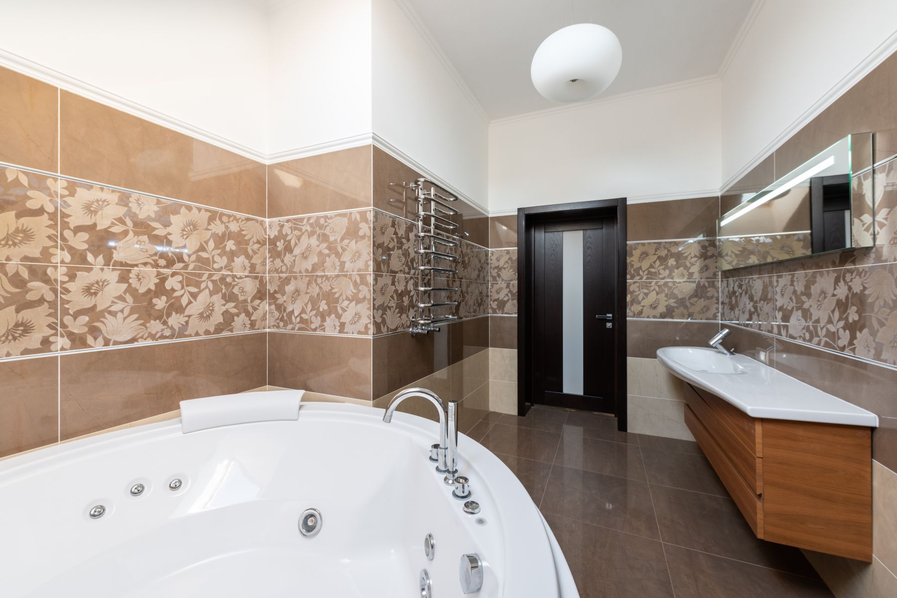 Bathroom with a soaking tub and patterned tile
