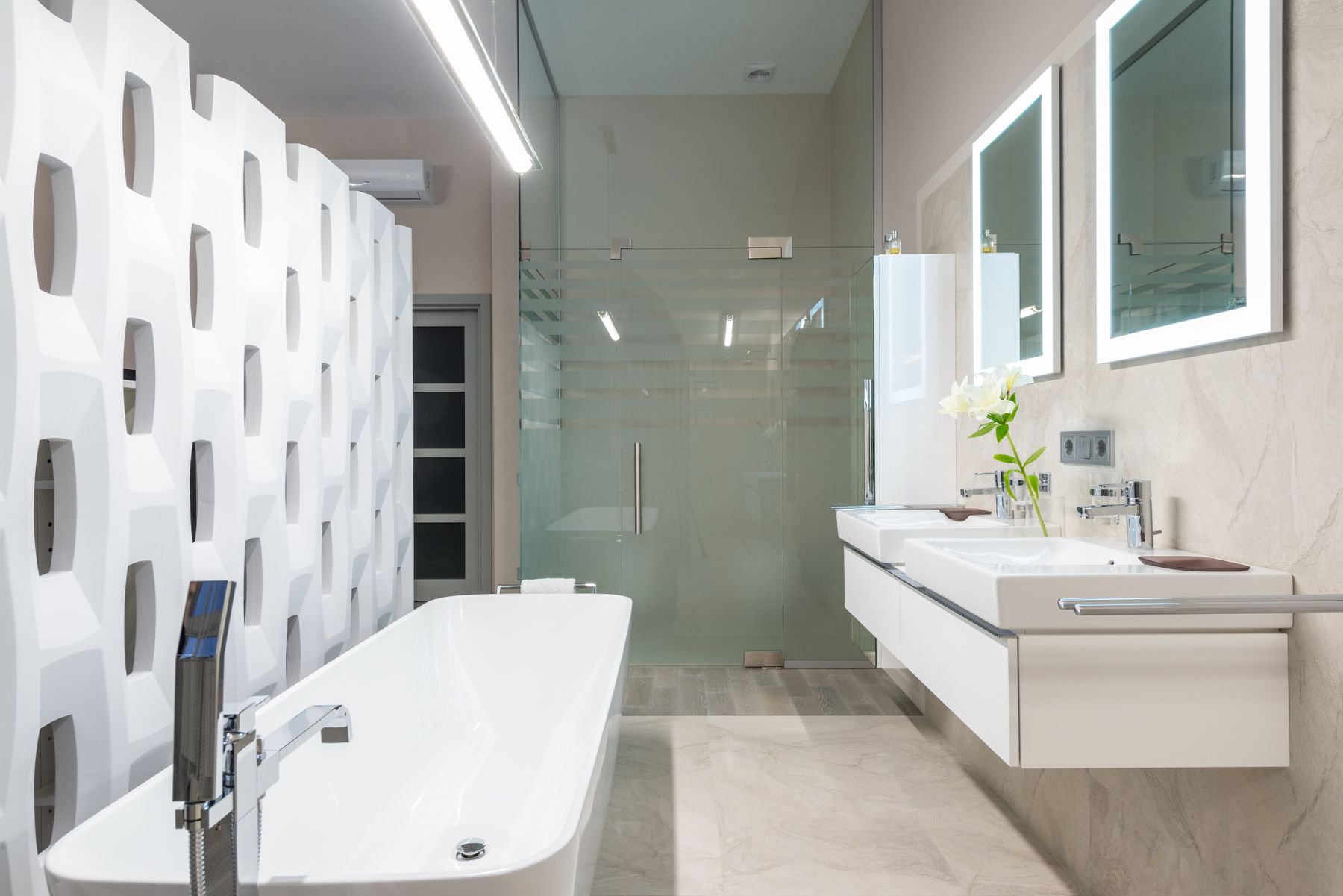 White bathroom with a freestanding tub and double vanity