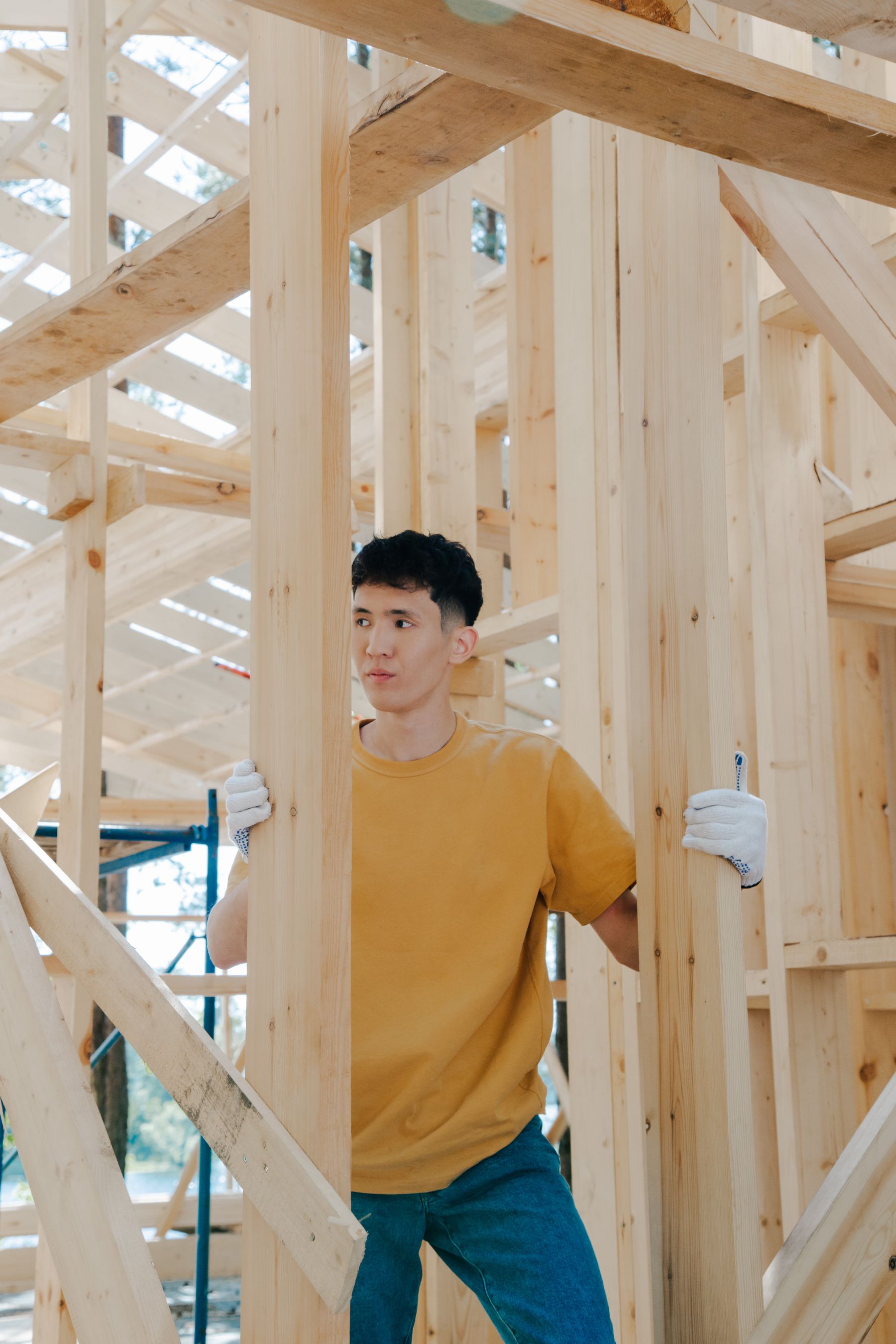 Carpenter standing inside new wall framing