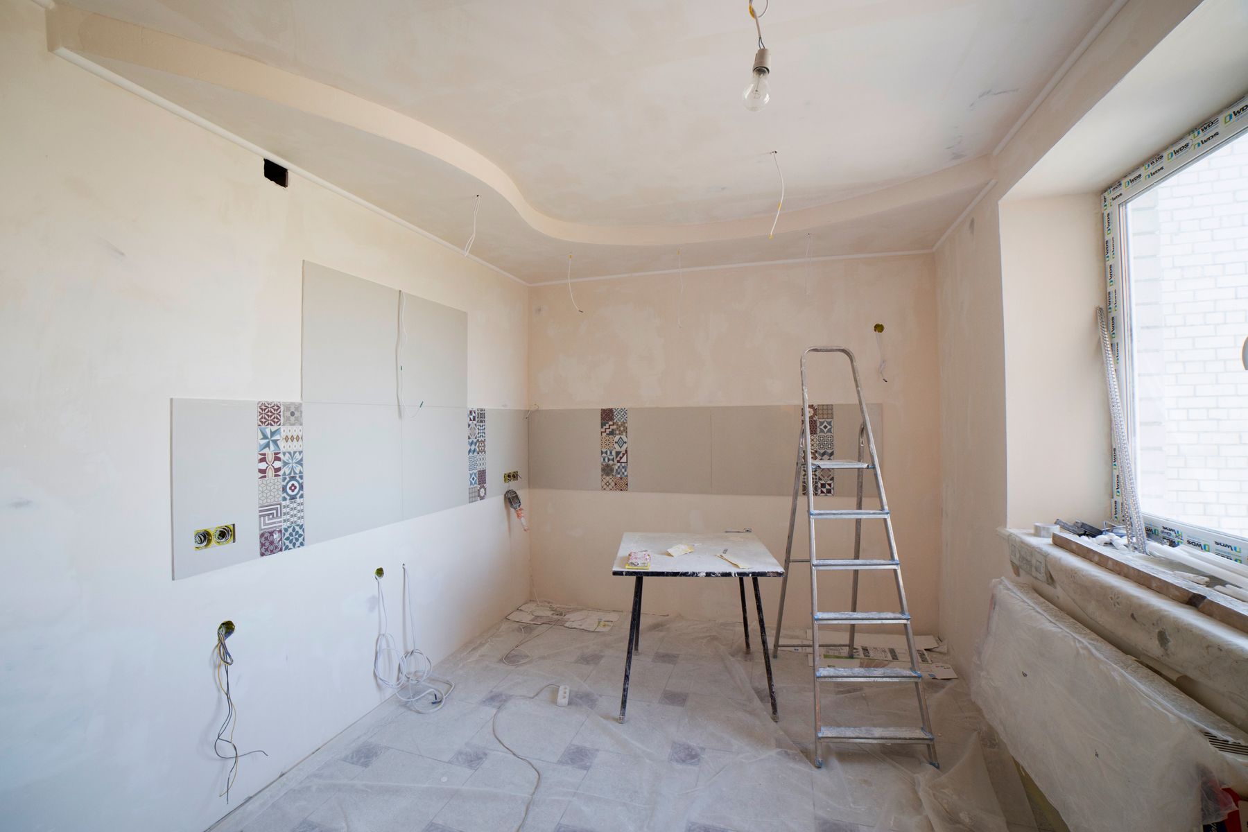 Kitchen stripped to bare walls in the middle of a renovation